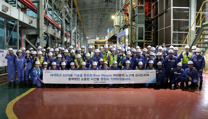 직원들이 "함께했던 소중한 시간들 영원히 기억하겠습니다"라는 현수막을 들고 단체사진을 찍고있다. 사진=포스코